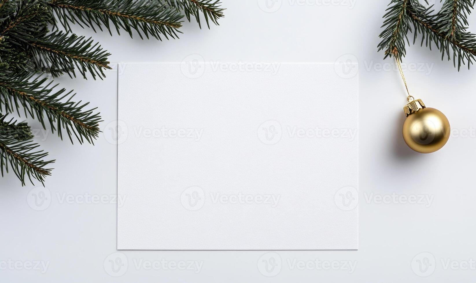 A white card with a gold ornament hanging from it photo