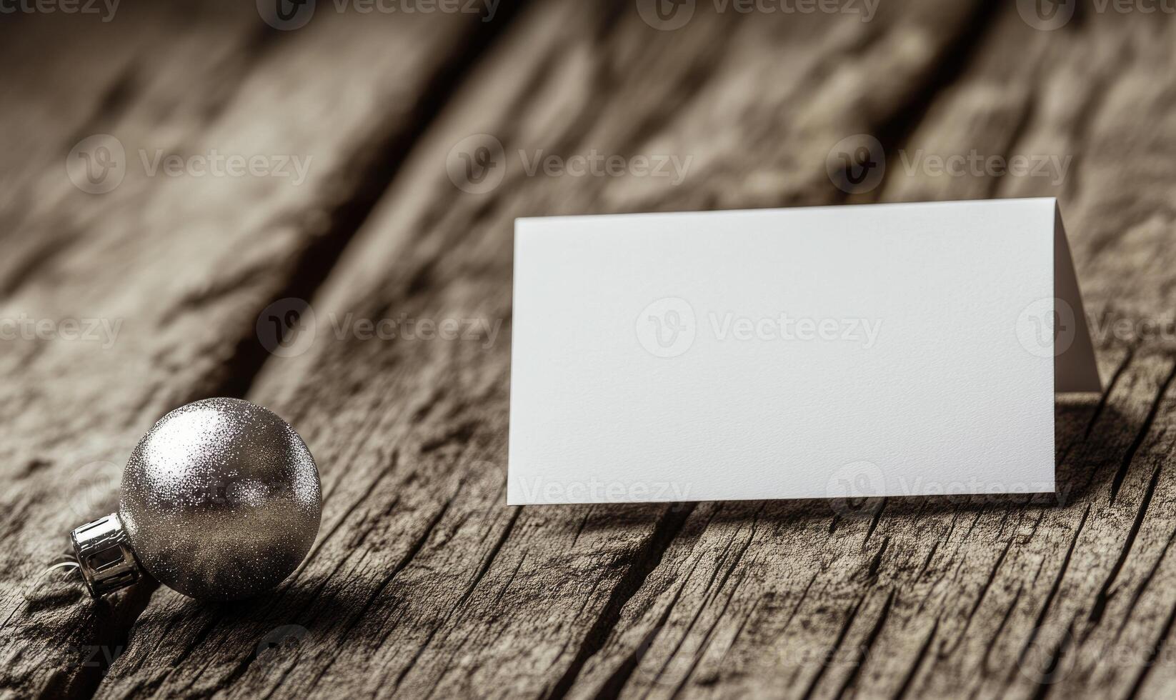 A white card with a silver ball on top of it photo