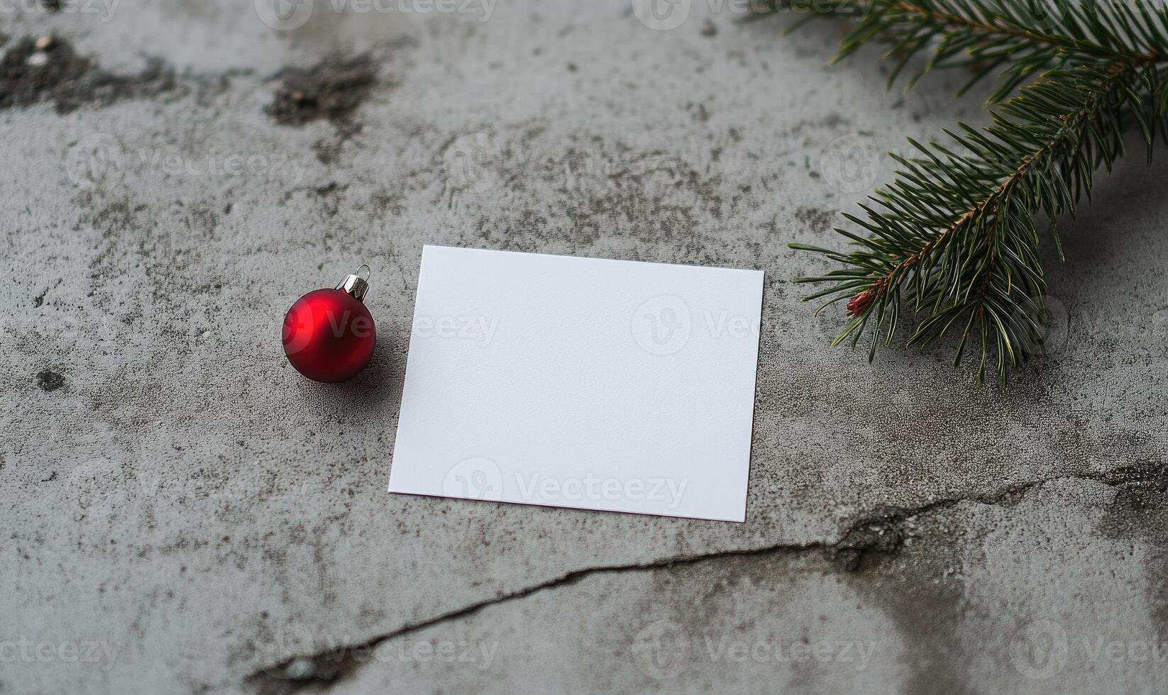 A white sign sits on a grey surface next to a red ornament photo