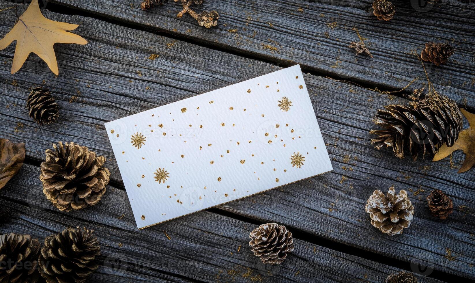 A white card with snowflakes on it sits on a wooden table photo