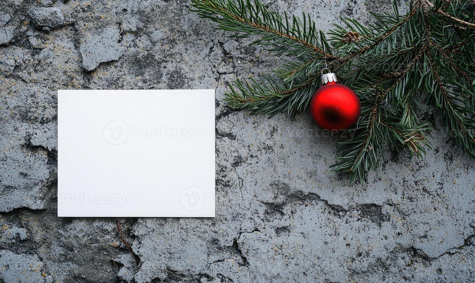 A white card with a red ornament hanging from a tree branch photo
