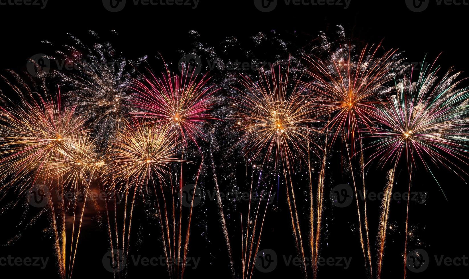 A row of fireworks are lit up in the sky photo