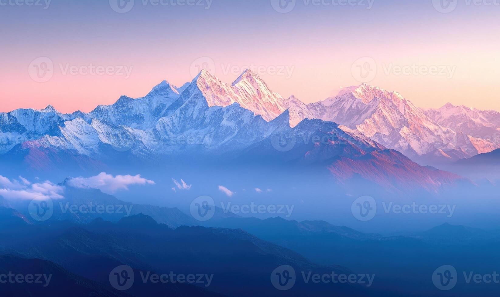 The mountains are covered in snow and the sky is a beautiful shade of pink photo