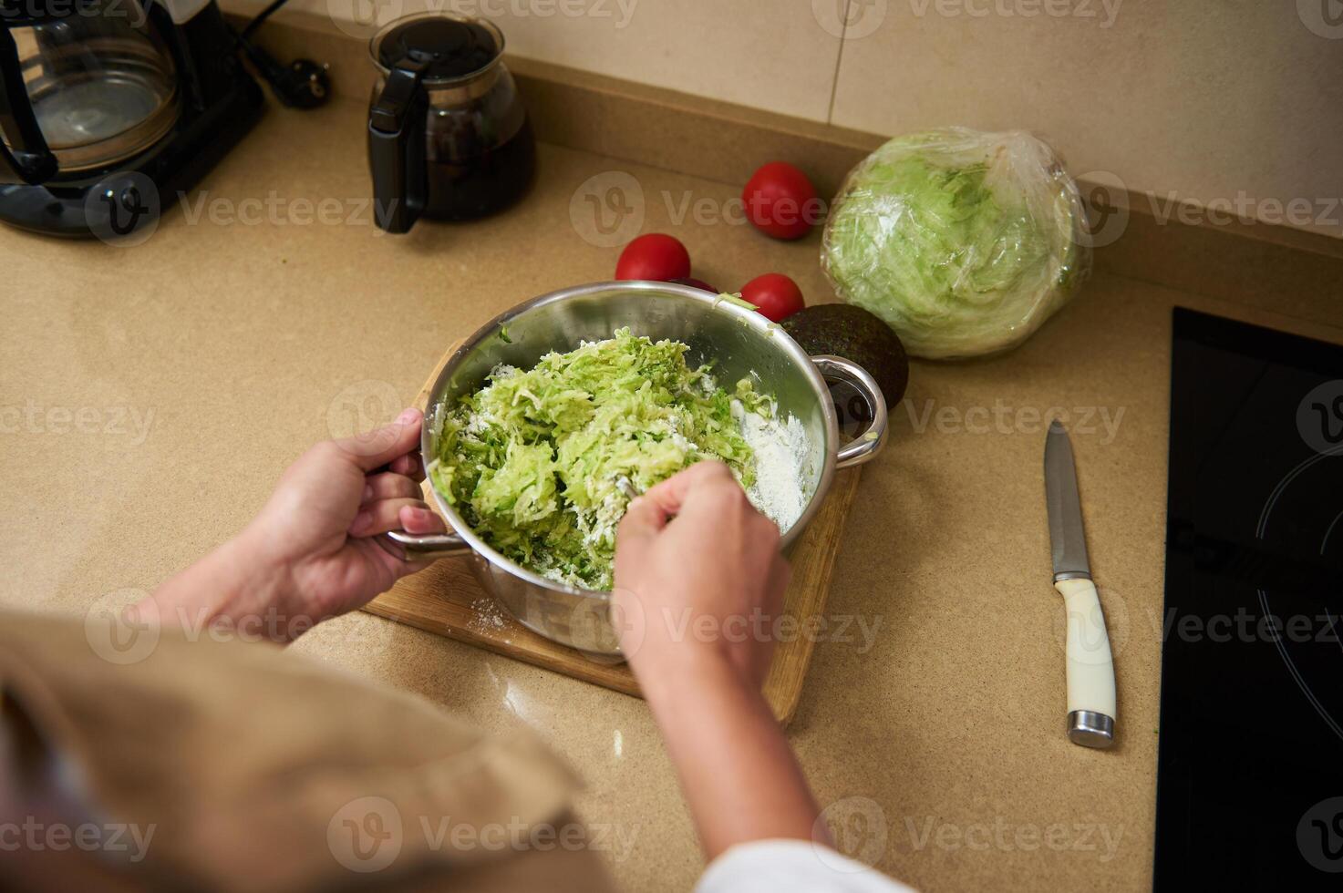 Preparing fresh lettuce salad in a modern home kitchen photo