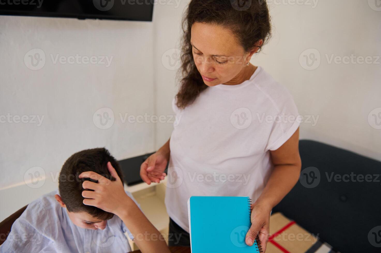Parent and child engaging in homework help session at home photo