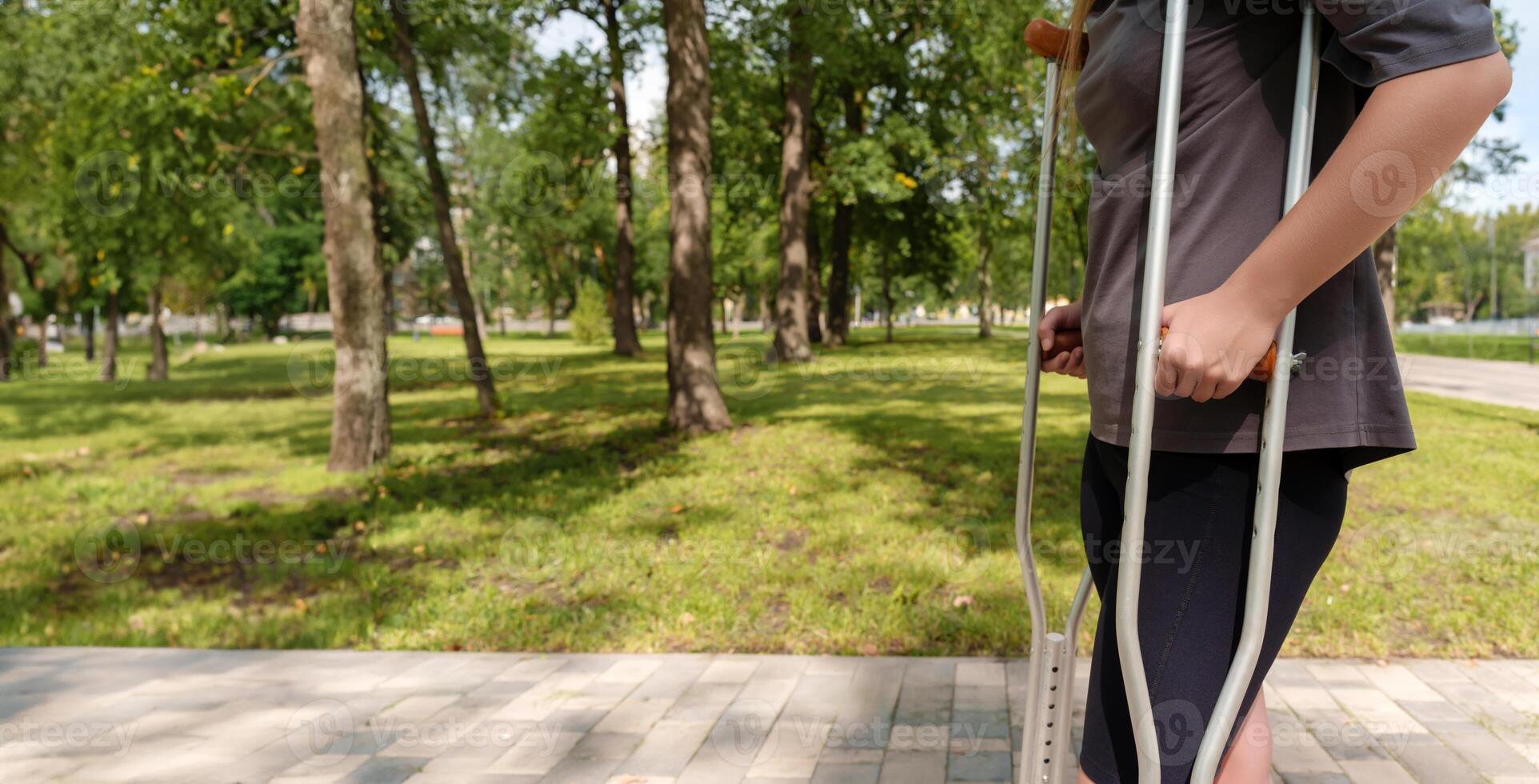 person with crutches strides forward, exemplifying the human capacity for resilience and the triumph of the human spirit photo