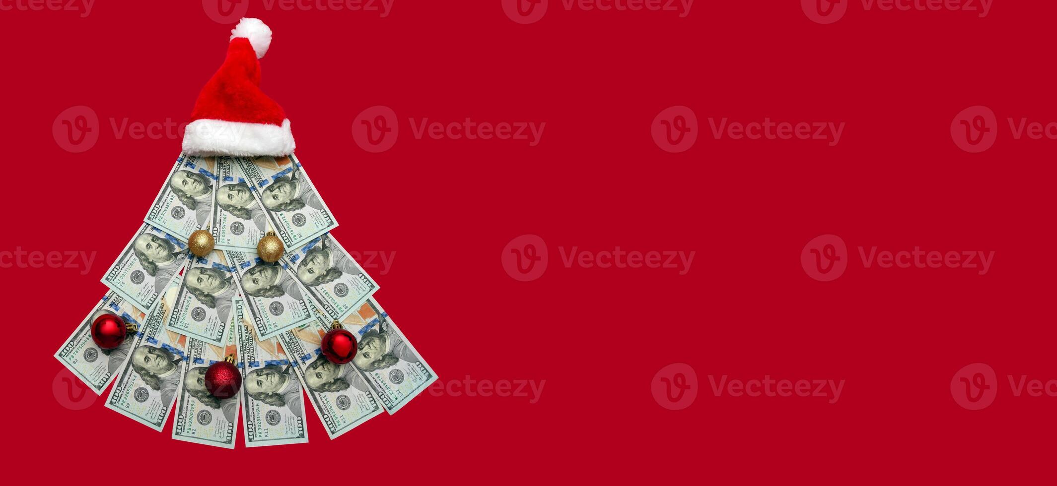 Christmas tree made of 100 dollar bills on a red background, Christmas decoration of finances, expenses, savings in the new year. Copyspace, banner photo