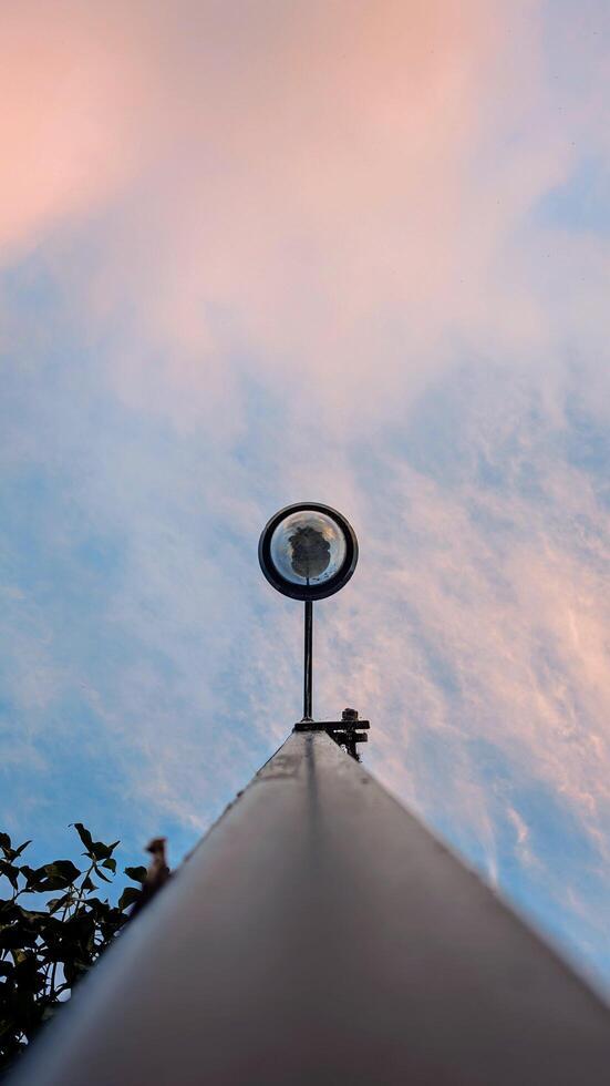 A street light with a blue sky and clouds photo