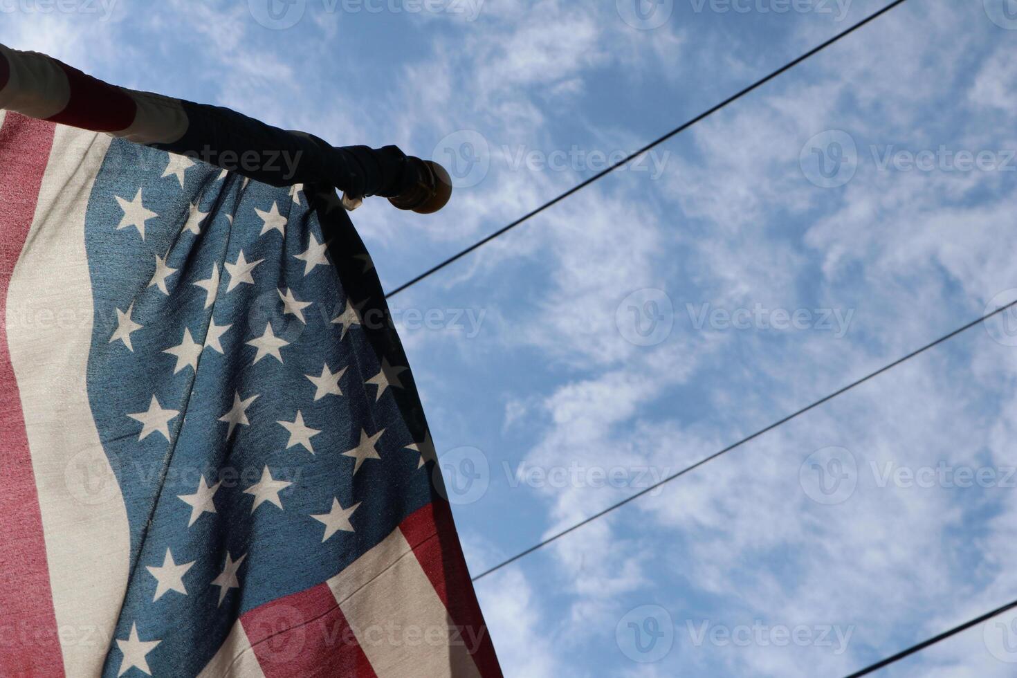 A flag is hanging from a pole photo