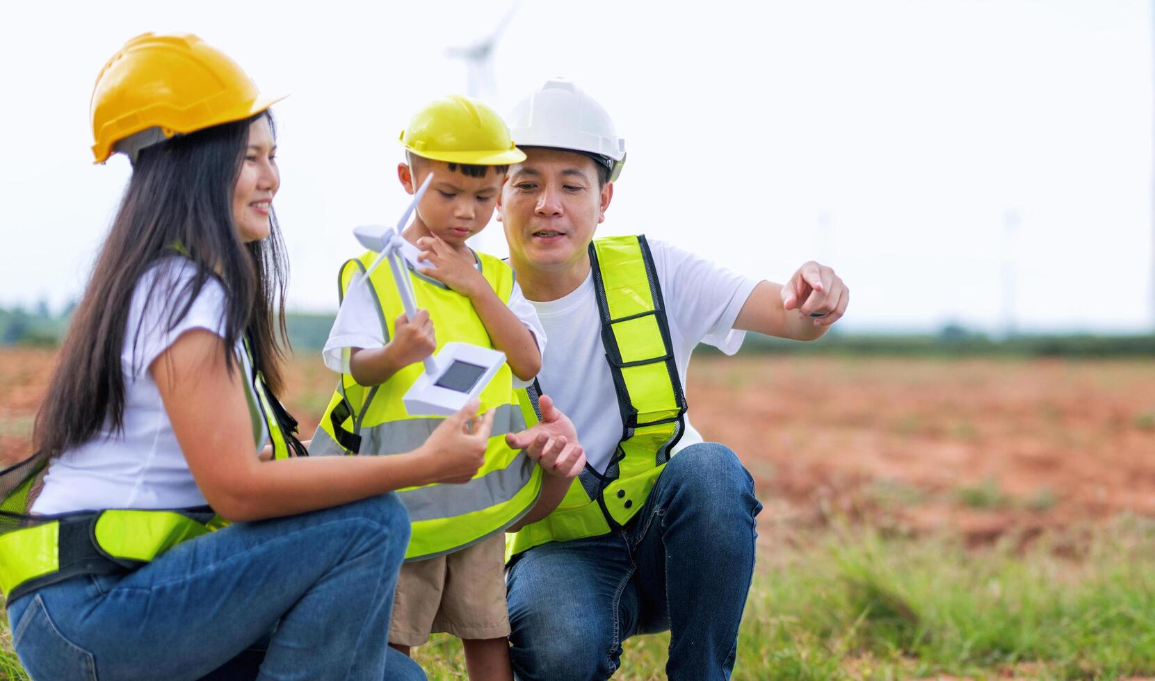 man and a child are looking at a device while a woman looks on photo