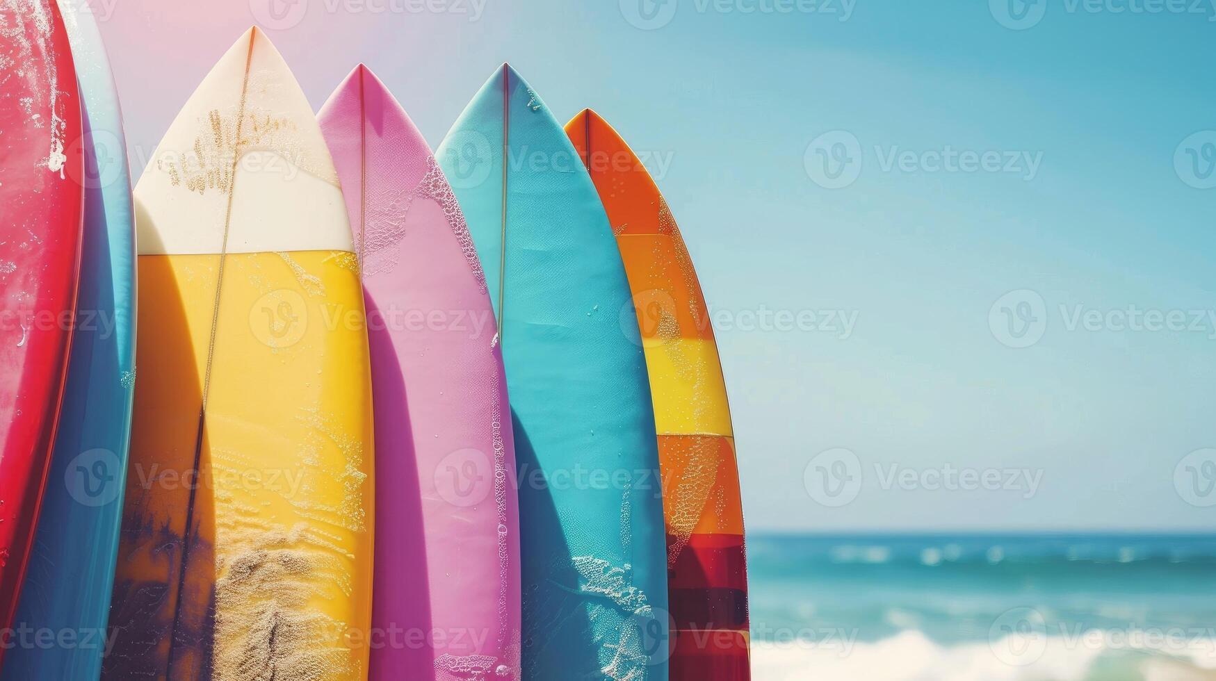 Colorful surfboards standing on a beautiful beach in summer time photo