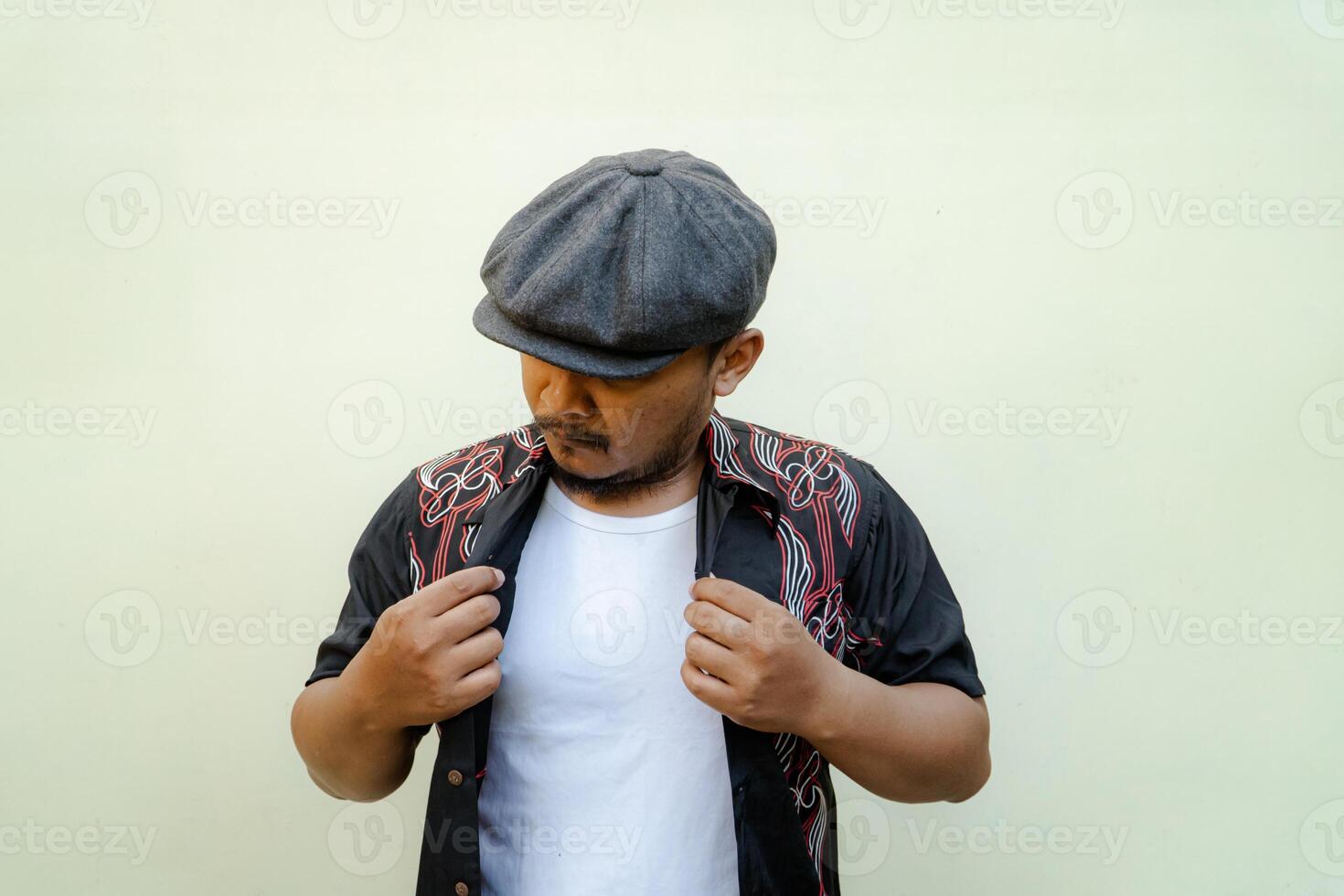 Half-length portrait of adult Southeast Asian man doing various poses and vintage style with hawaiian shirt, white tank top and newsboys cap on beige background photo