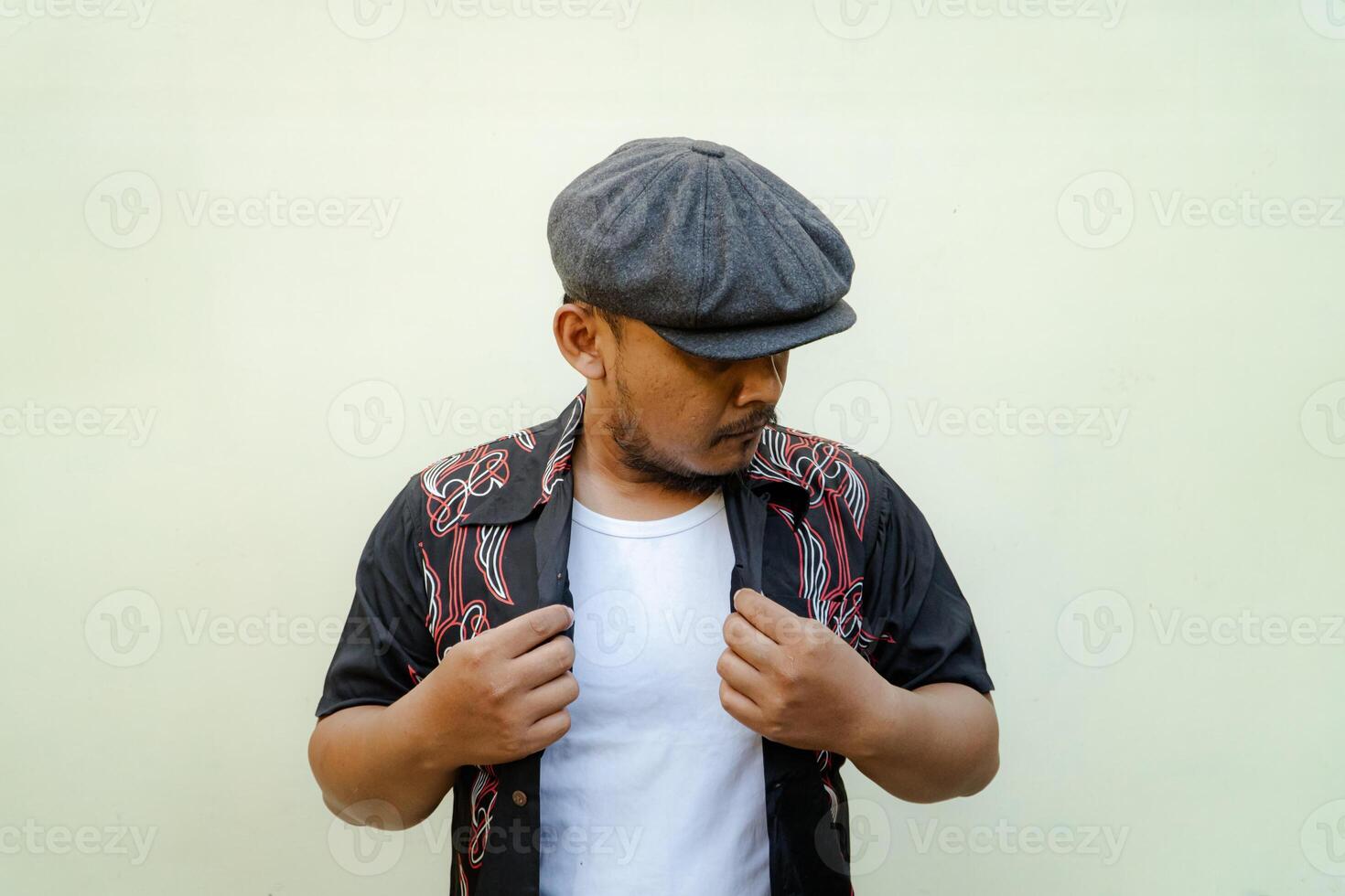 Half-length portrait of adult Southeast Asian man doing various poses and vintage style with hawaiian shirt, white tank top and newsboys cap on beige background photo