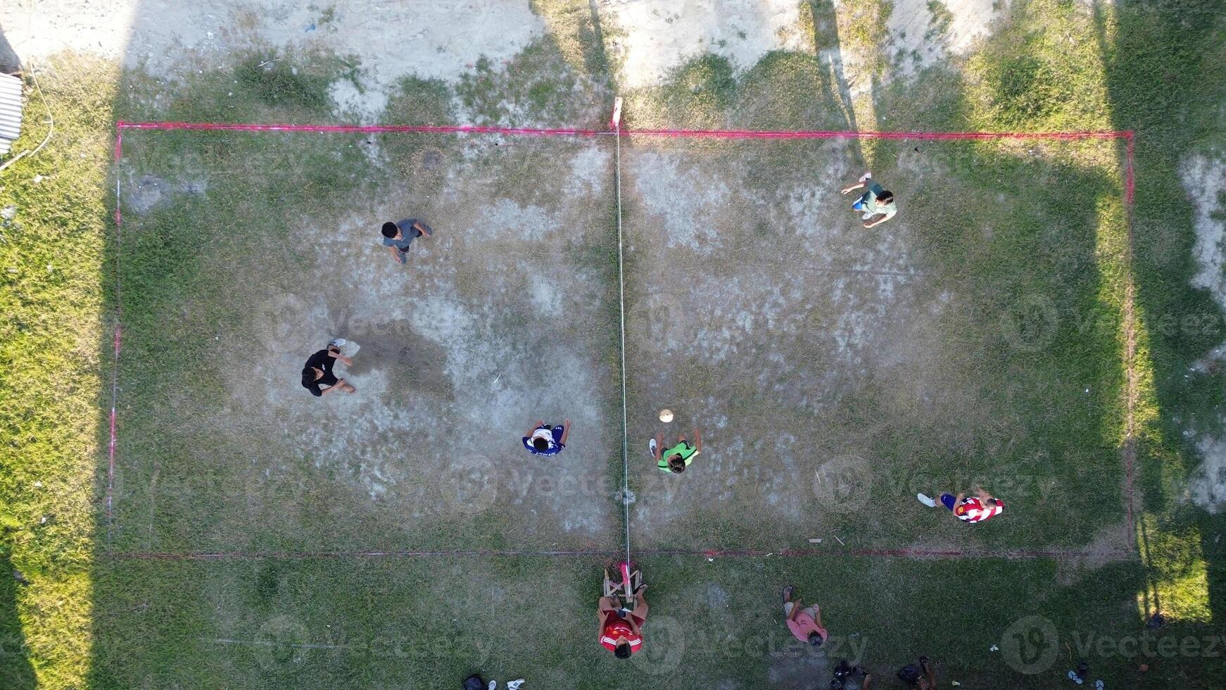 Aerial view of group of young men are playing takraw in the afternoon photo