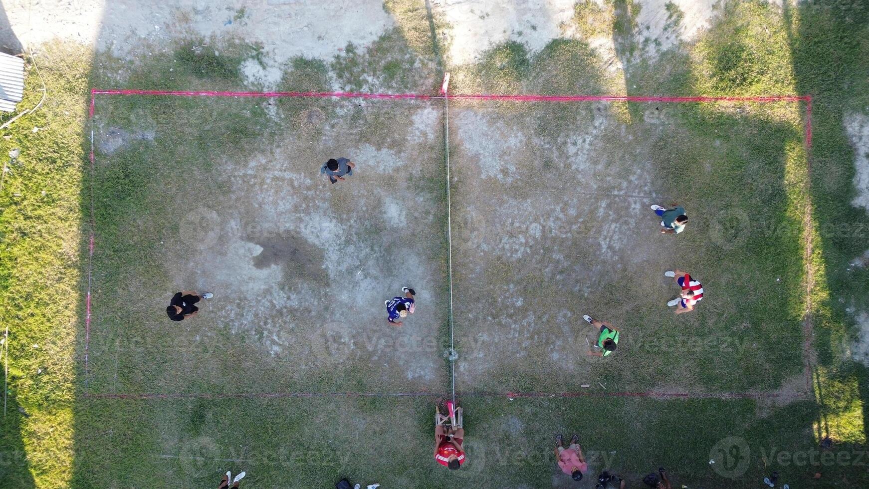 Aerial view of group of young men are playing takraw in the afternoon photo