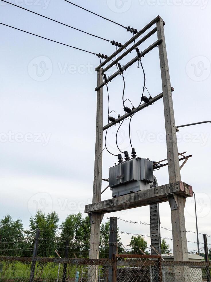 The electrical transformer installed on the concrete pole. photo
