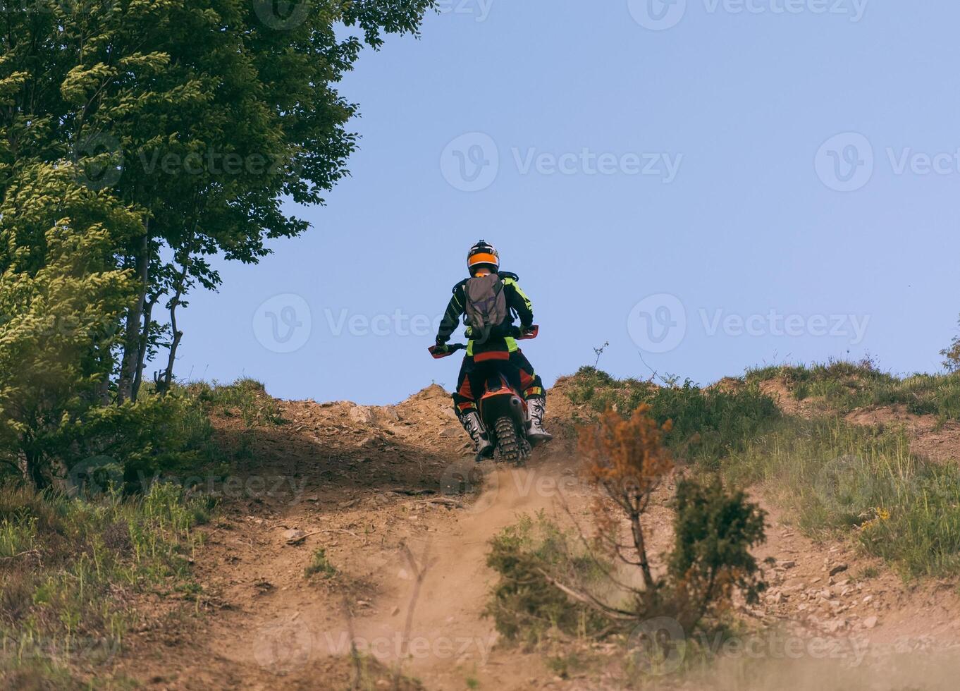 Professional enduro bike rider on action, dirt ride on the muddy road. Motocross sport. photo