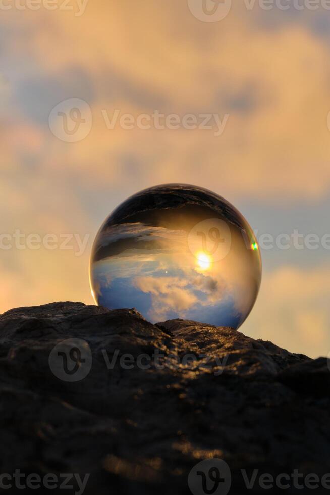 The landscape view on a nature through a glass ball with a blurred background creative photography photo