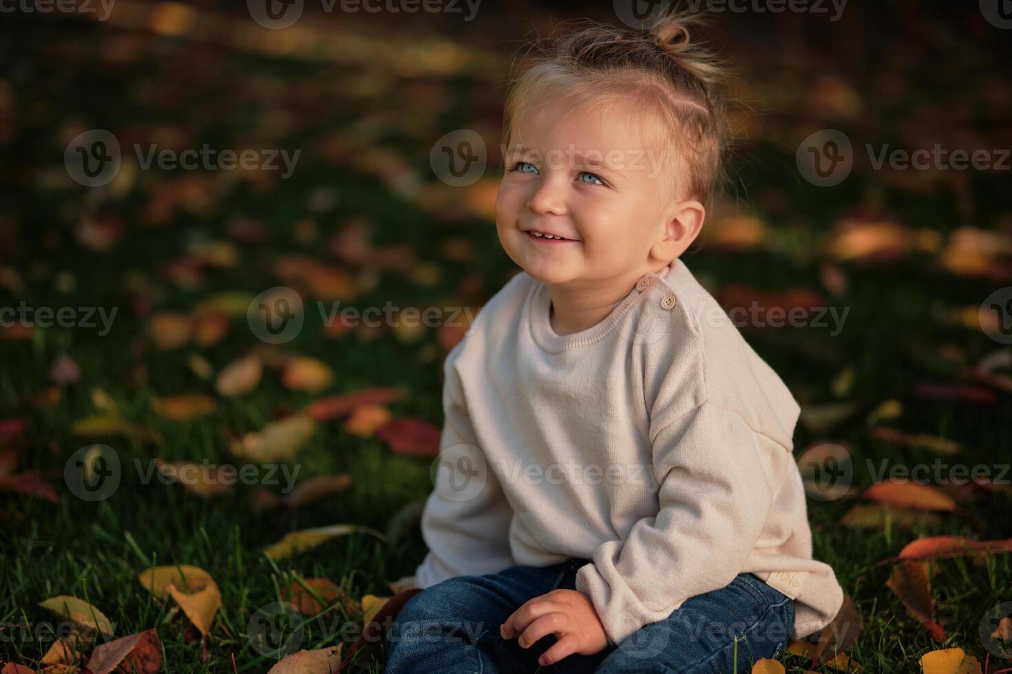 A smiling toddler child isolated on the nature background. photo