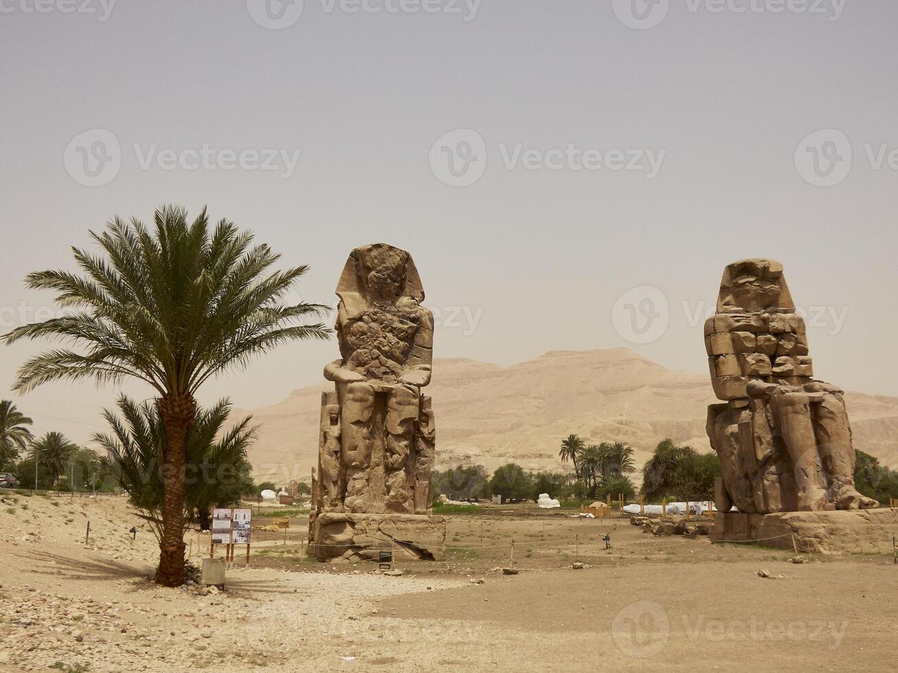The Colossi of Memnon, two stone massive statues of the Pharaoh Amenhotep III, who reigned in Egypt during the Dynasty XVIII. photo