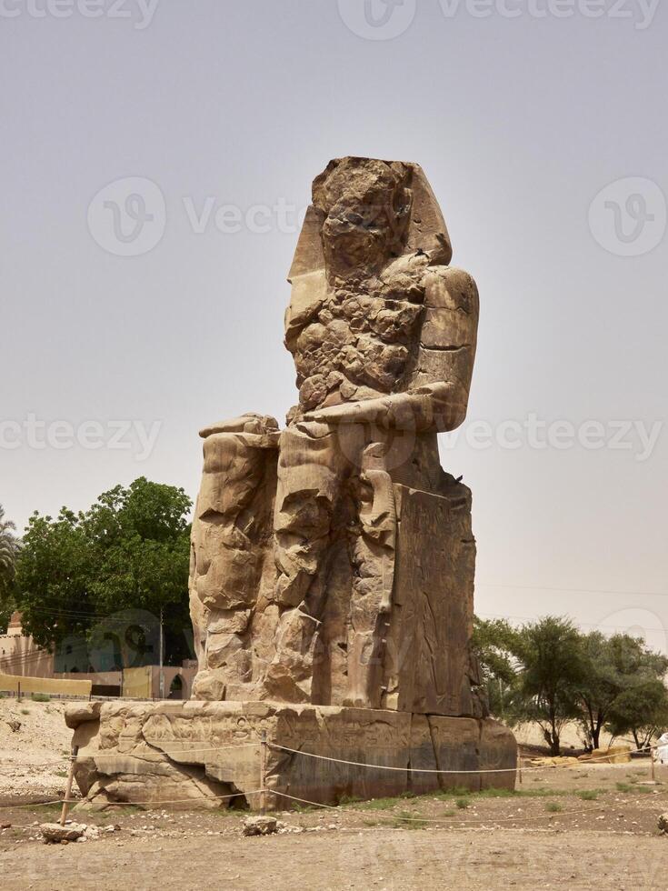 The Colossi of Memnon, two stone massive statues of the Pharaoh Amenhotep III, who reigned in Egypt during the Dynasty XVIII. photo