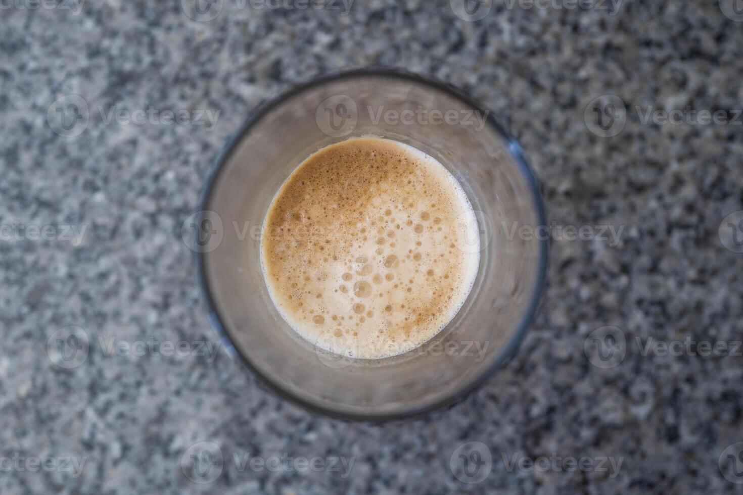 Closeup espresso shot on the stone table photo