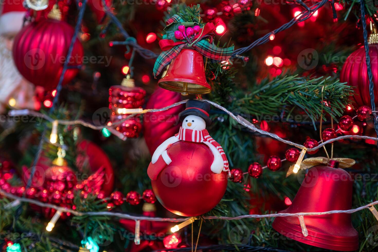 front view for christmas tree with focus on it is red decorations photo