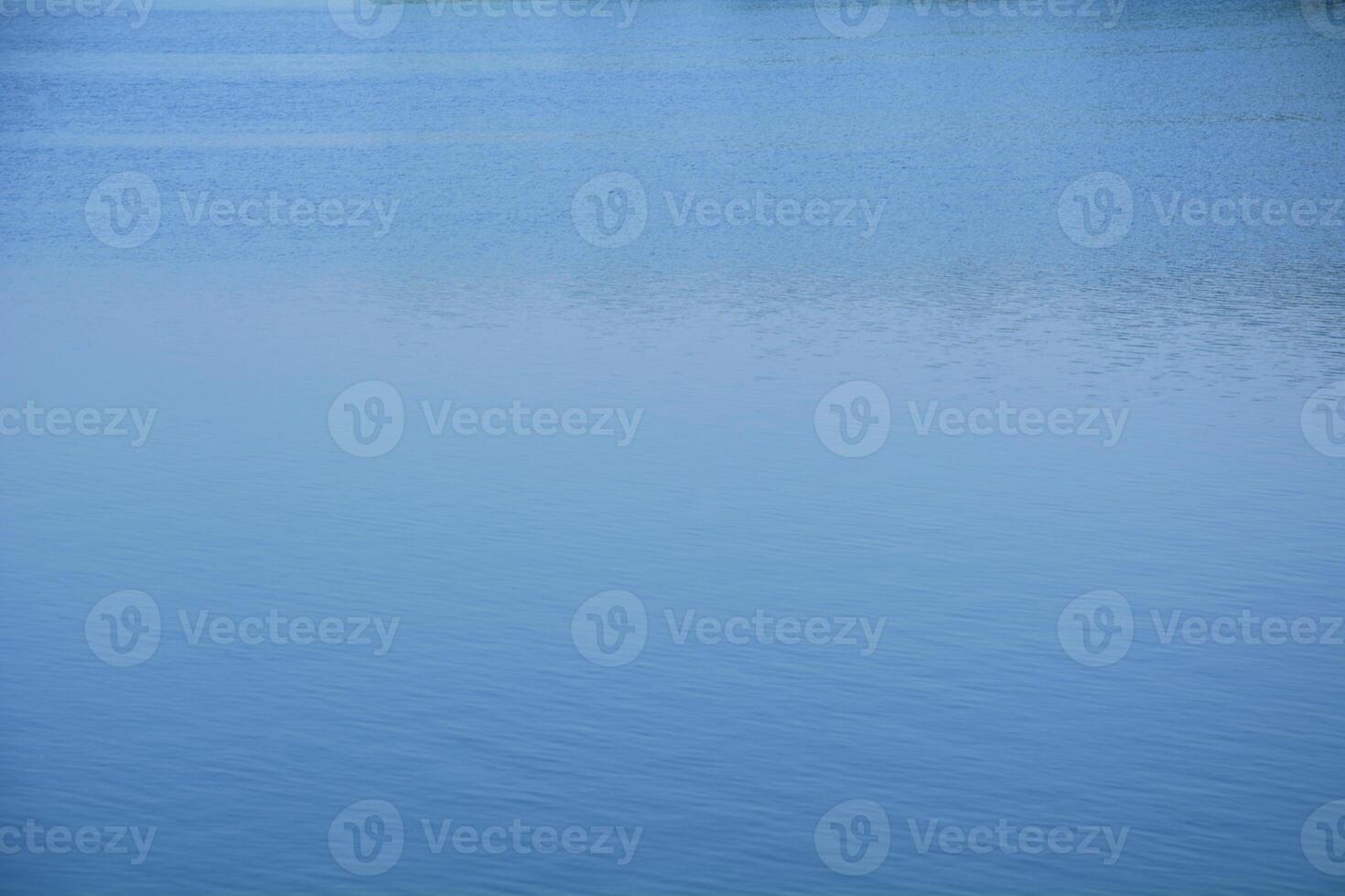 A man is flying a kite in the water photo