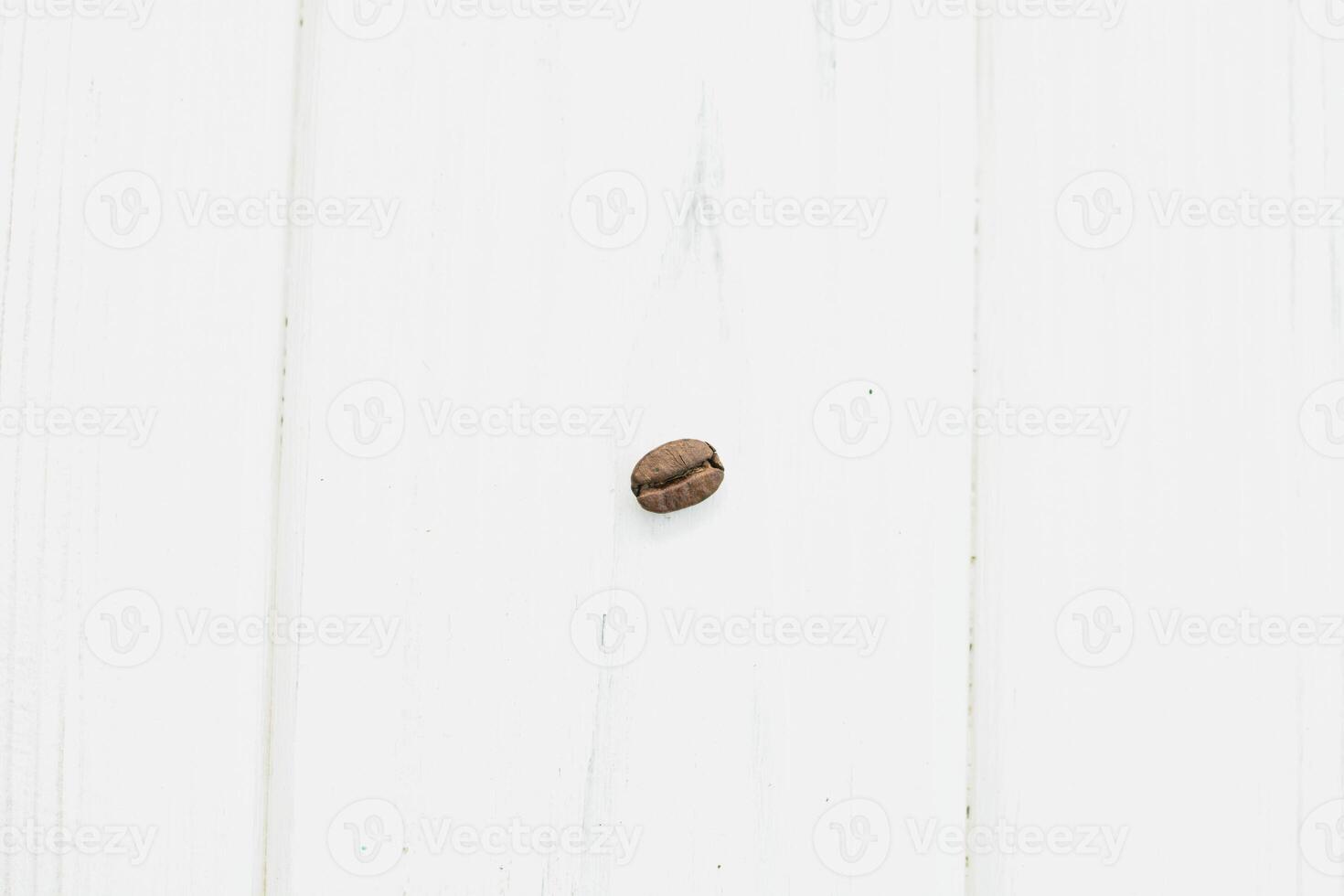A coffee bean on a white wooden table photo