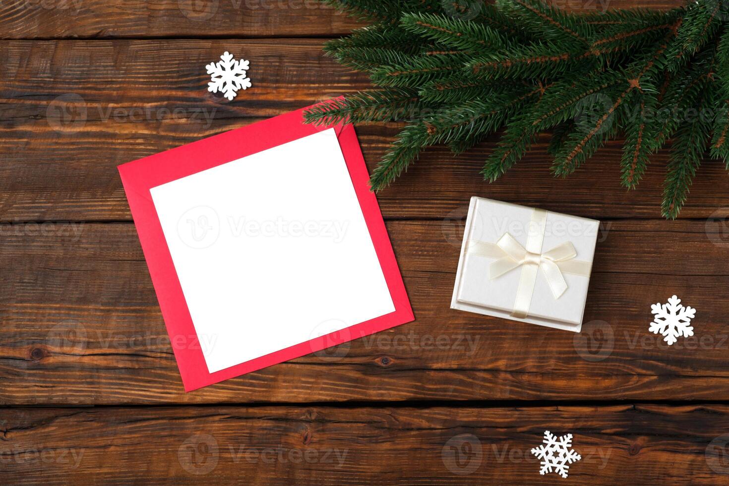 Blank square paper mockup envelope red, gift box on wooden vintage table background. photo