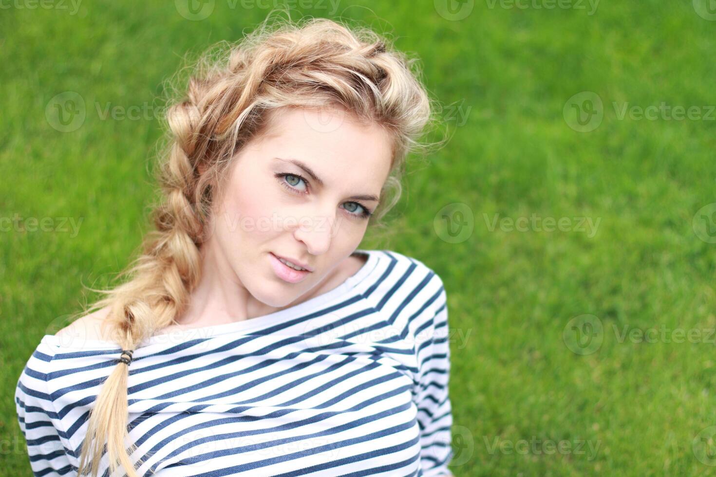 Girl on the green grass photo