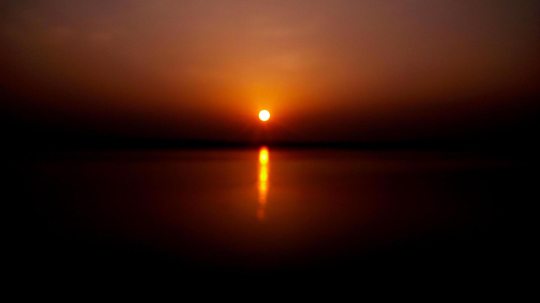 Sunset over the river ganges photo