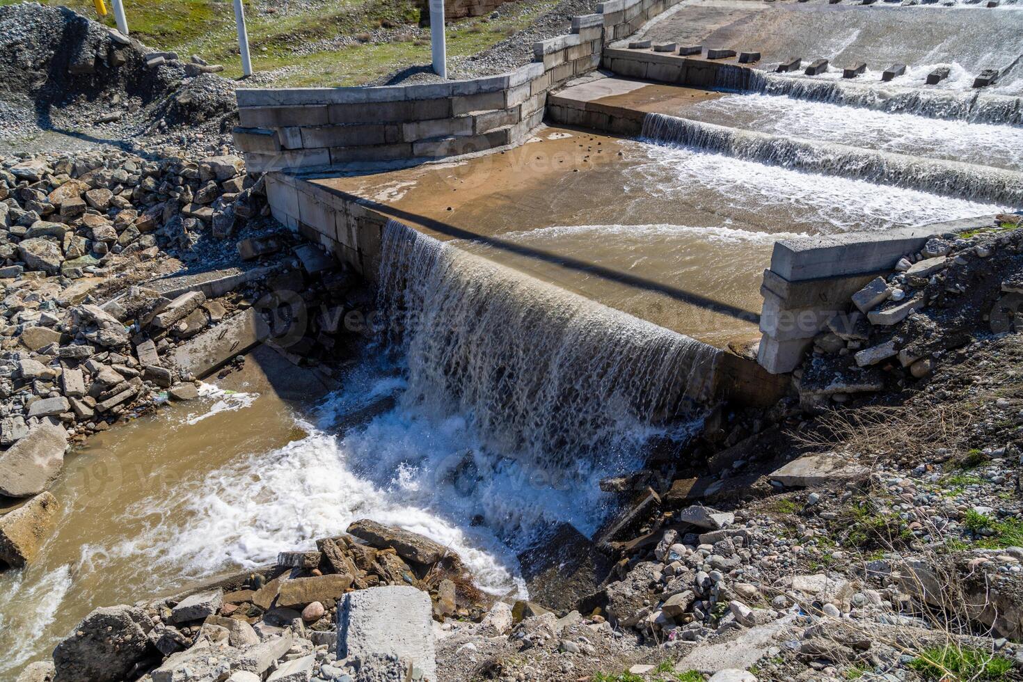 chute dentate blocks in cascade concrete water spillway channel photo