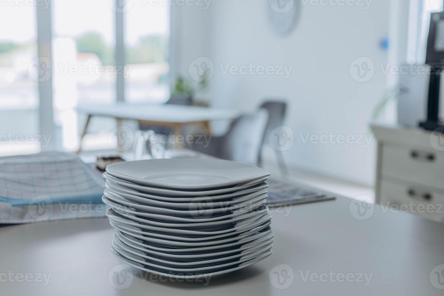 Stack of white plates prepared for serving, clean and ready for table setting. photo