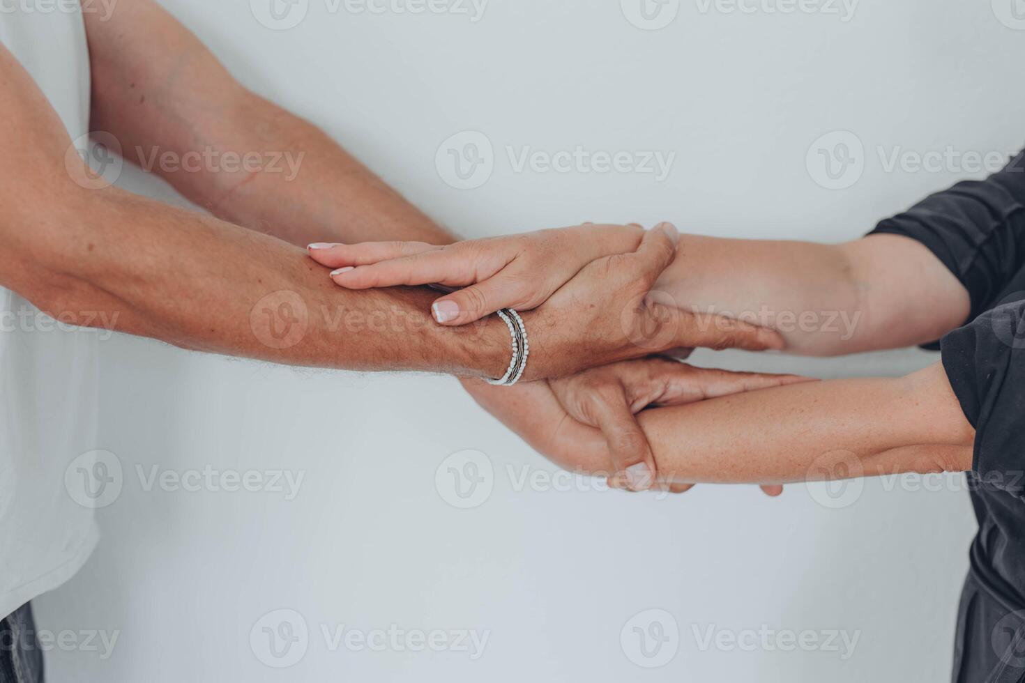 Two hands hold tightly to each other, rescuer saves, pulls out of trouble a person in need of help photo