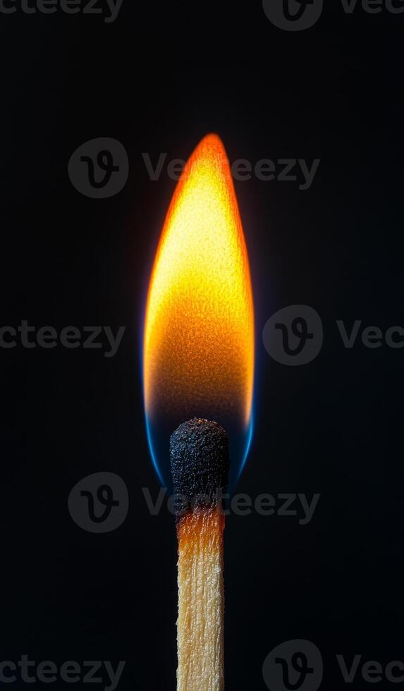 A matchstick is lit and the flame is yellow. Concept of warmth and comfort, as well as a reminder of the potential danger of fire photo