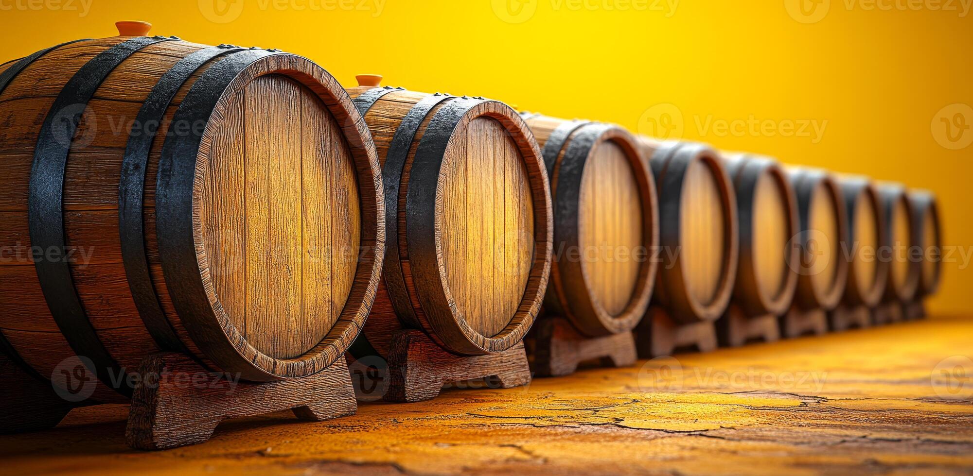 A row of wooden barrels with a yellow background. The barrels are lined up and appear to be empty photo