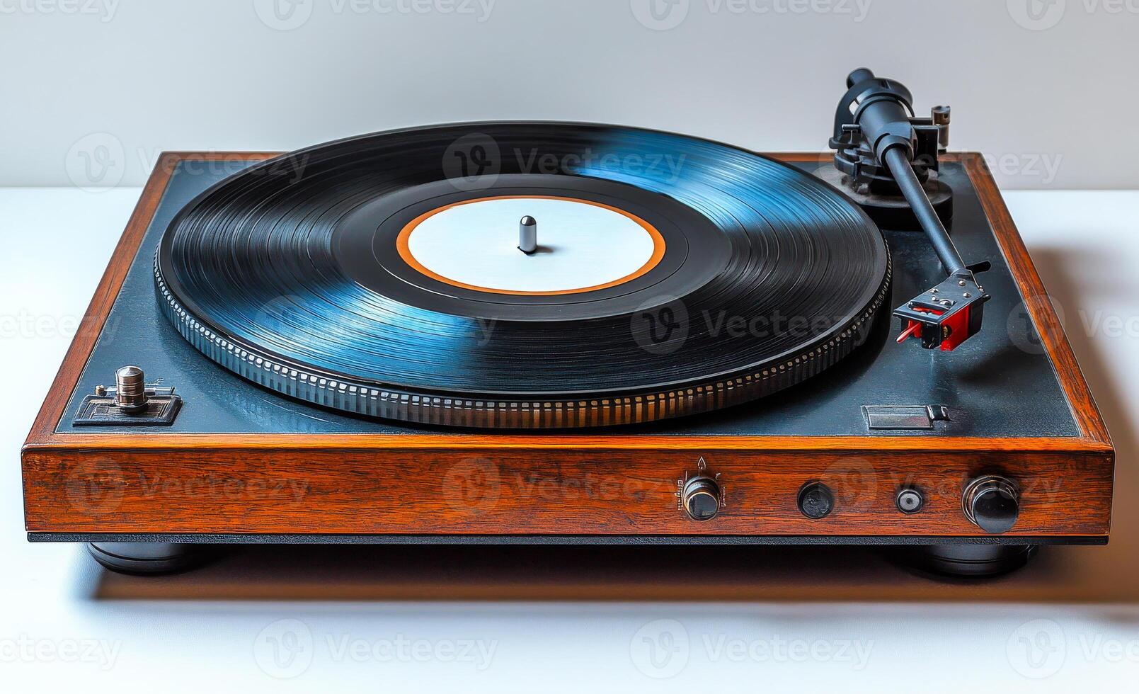 A vintage record player with a black record on it sits on a wooden surface. The record player is made of wood and has a black and white record photo