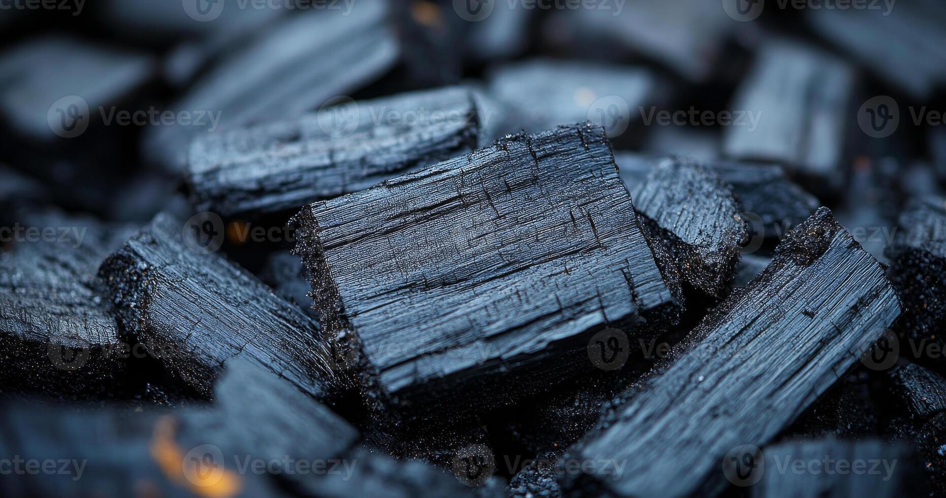 A pile of black wood with a lot of cracks and splinters. The wood is black and rough, and it looks like it has been used for a long time photo