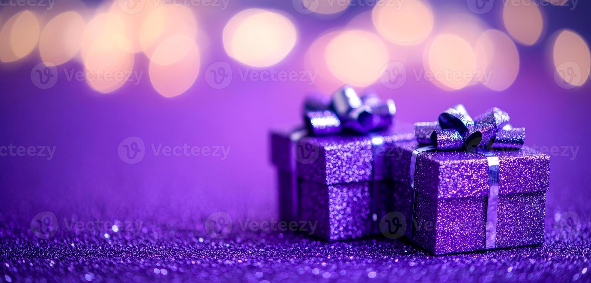 Two purple boxes with ribbons on top of a purple background. The boxes are decorated and appear to be gifts photo