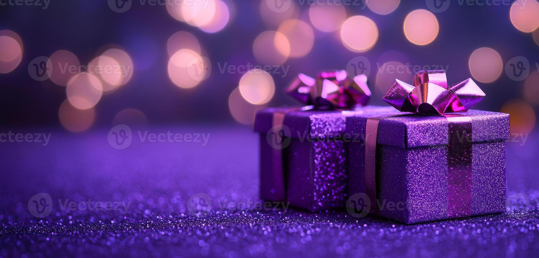 Two purple boxes with ribbons on top of a purple background. The boxes are decorated and appear to be gifts photo