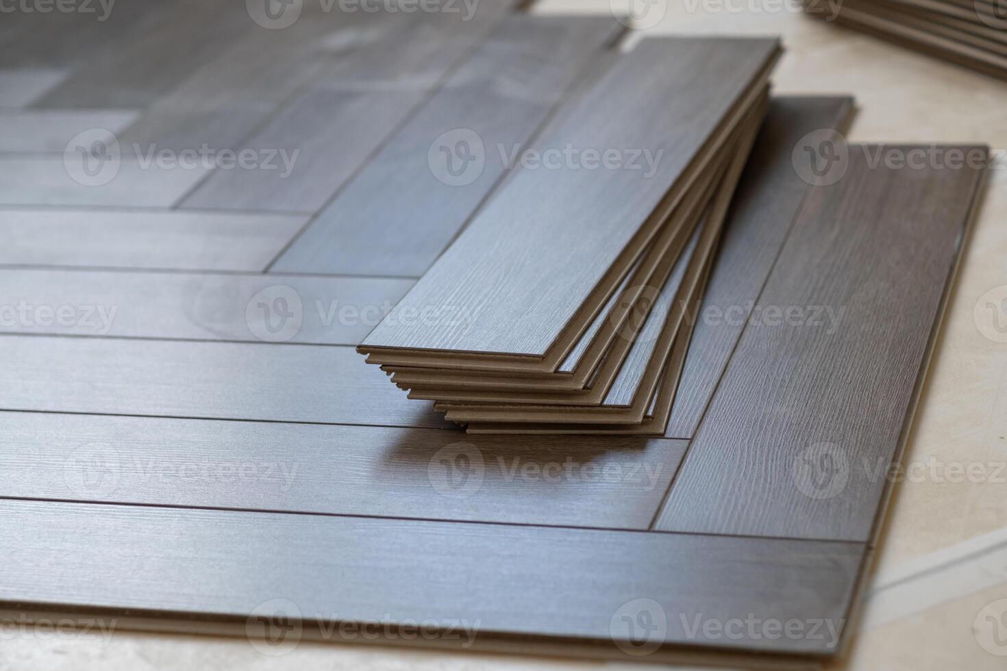 Professional laminate flooring installation in a bright apartment. Wood planks photo