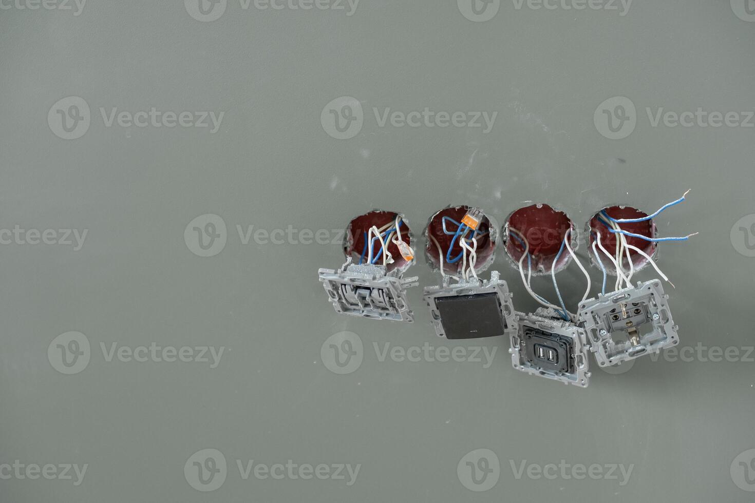 Several circuit board components with exposed wires are seen buoyantly resting on the tranquil water's surface photo