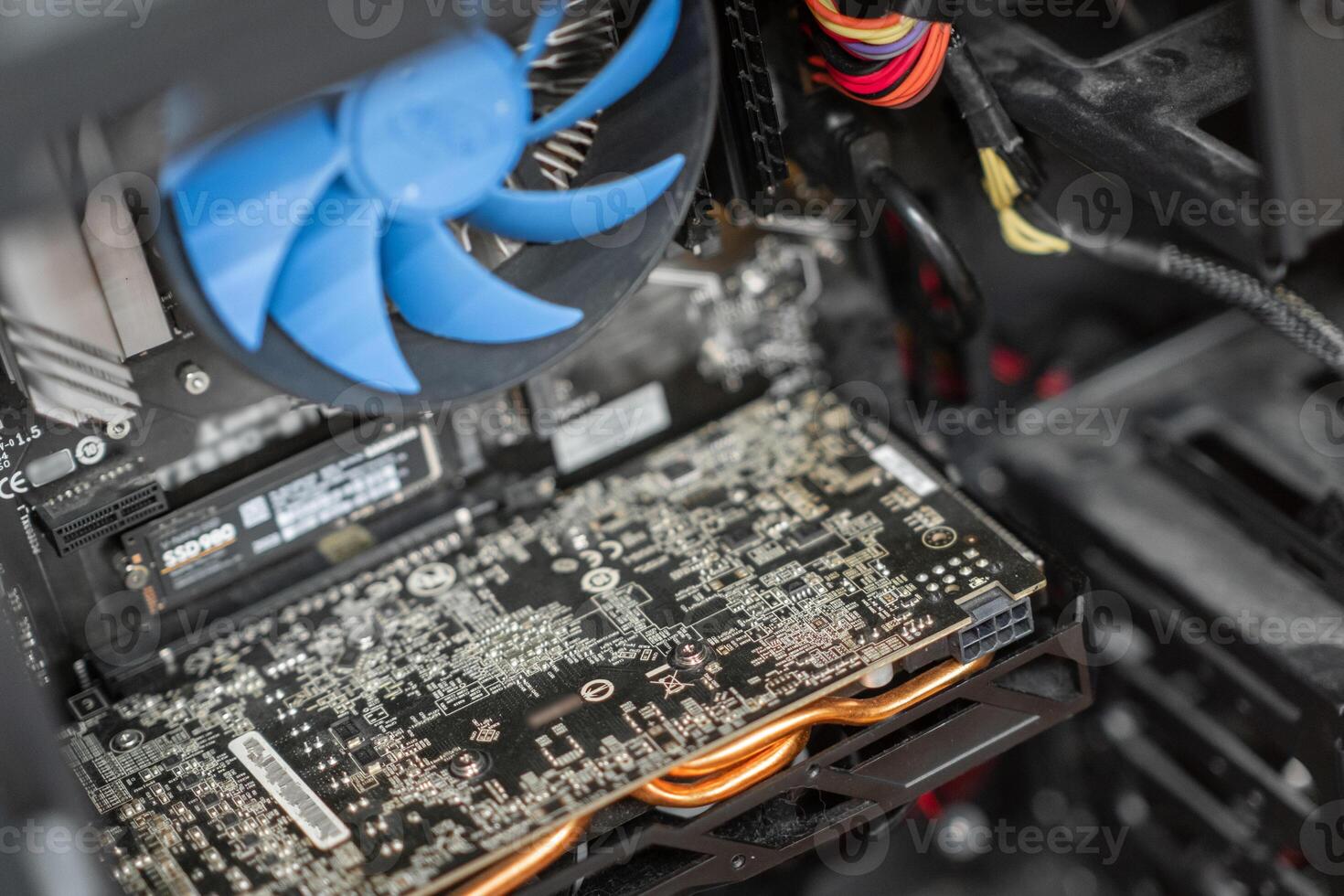 A close-up view of a computer's internal components highlighting the graphics card and cooling system during a routine check-up photo