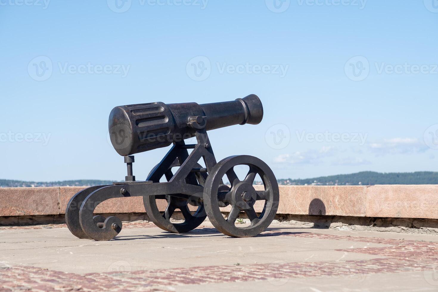 A historic cannon from the Alexander factory stands on the embankment of Lake Onega in Petrozavodsk, highlighting the scenic view photo