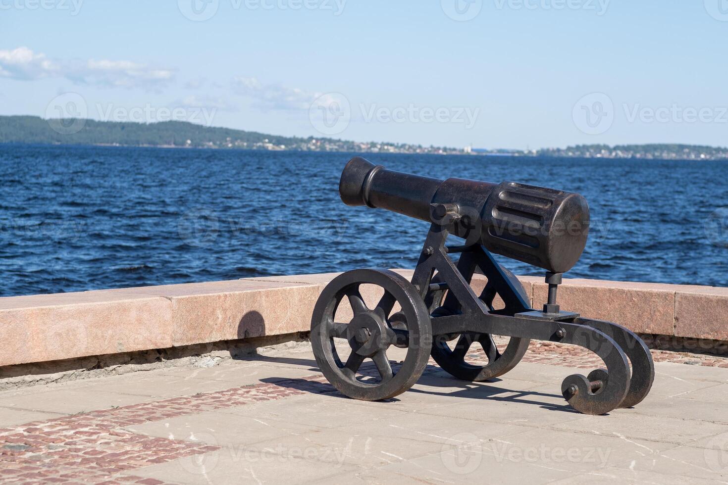 The cannon stands prominently on the shores of Lake Onega, overlooking the water and highlighting local historical significance photo