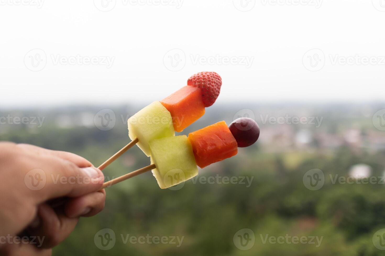 Fresh Fruit Skewers with Scenic View. photo