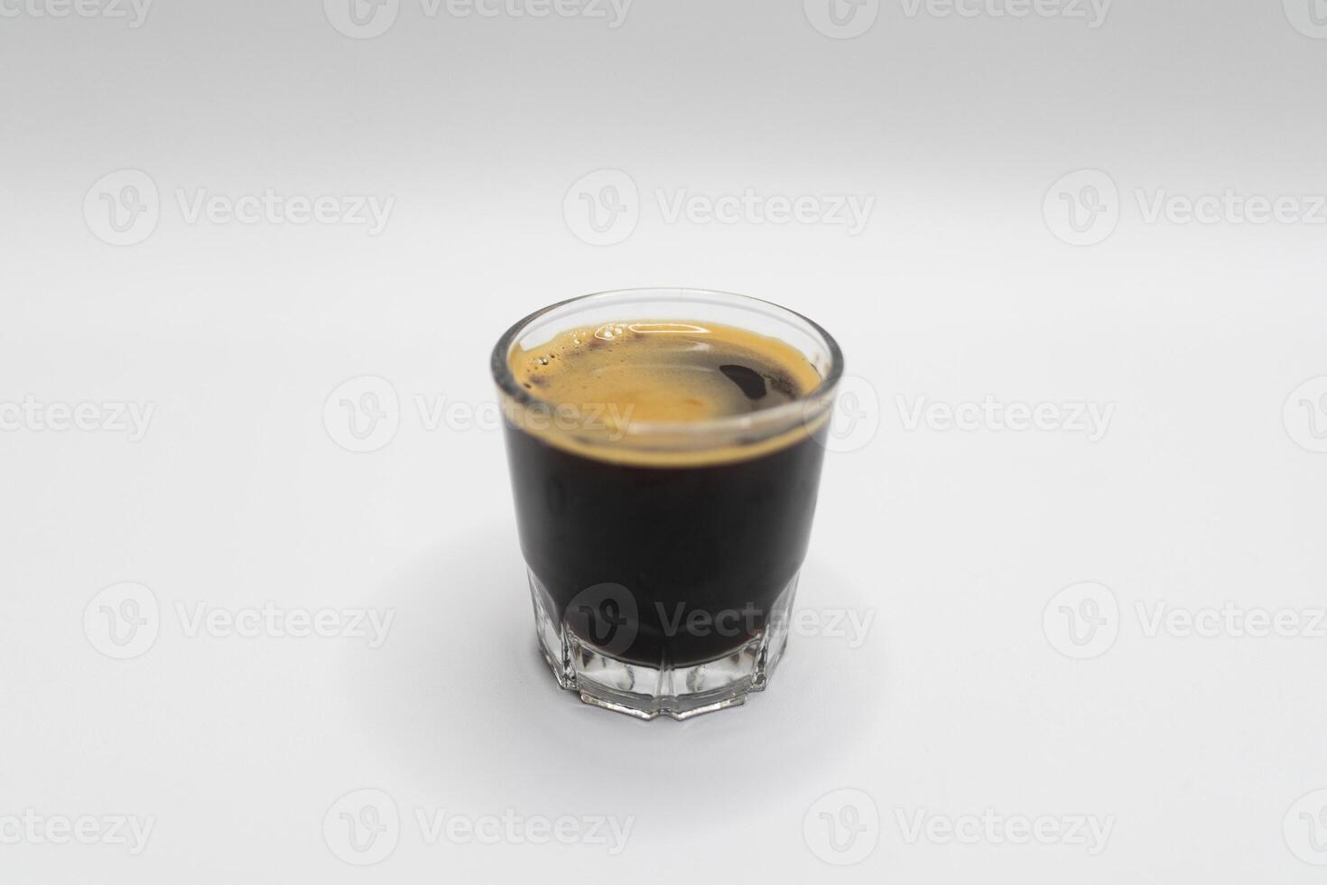 Black Coffee Espresso with Crema in Glass on White Background. photo
