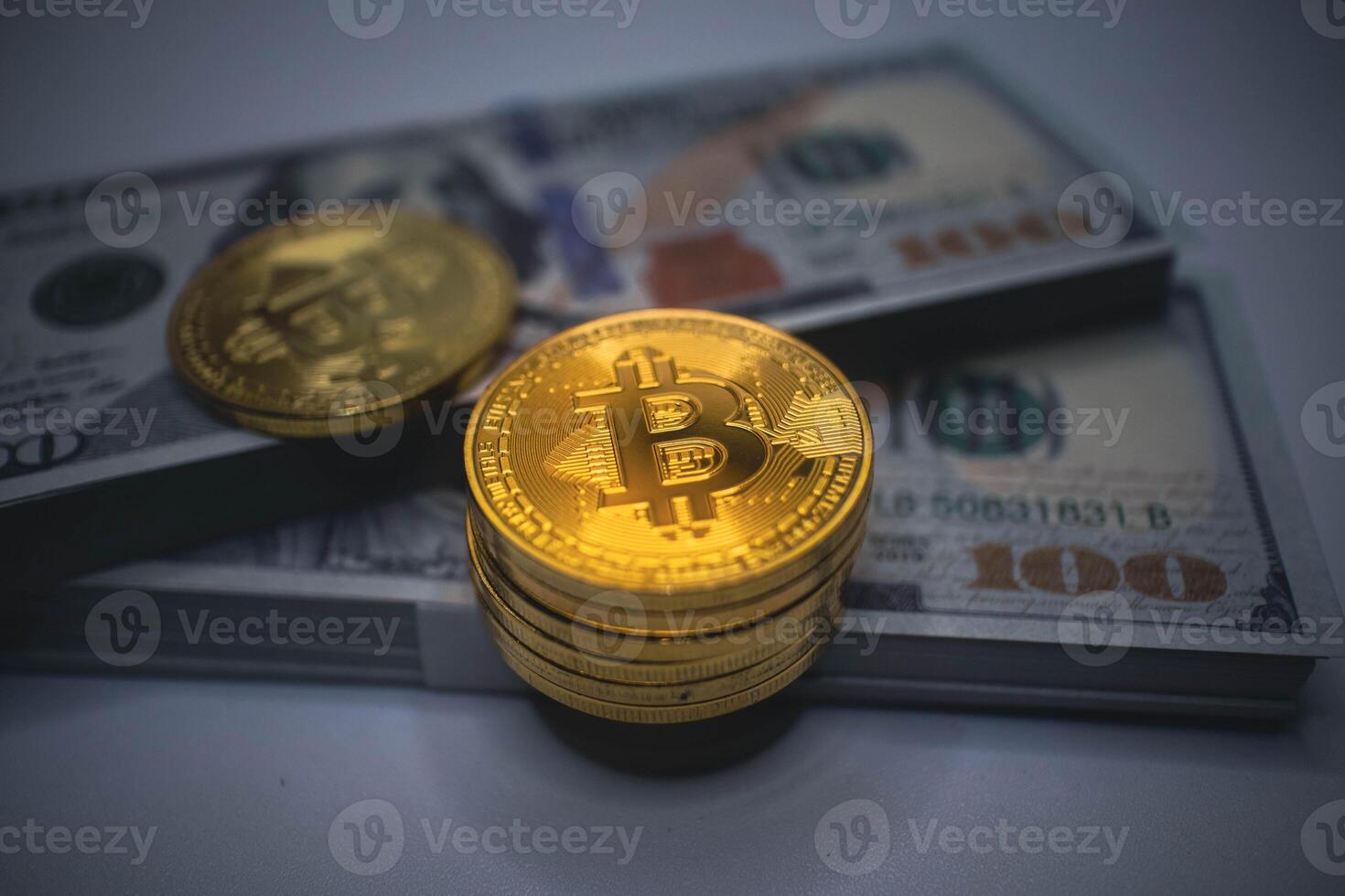 Golden Bitcoin Coins with US Dollar Bills in the Background. photo