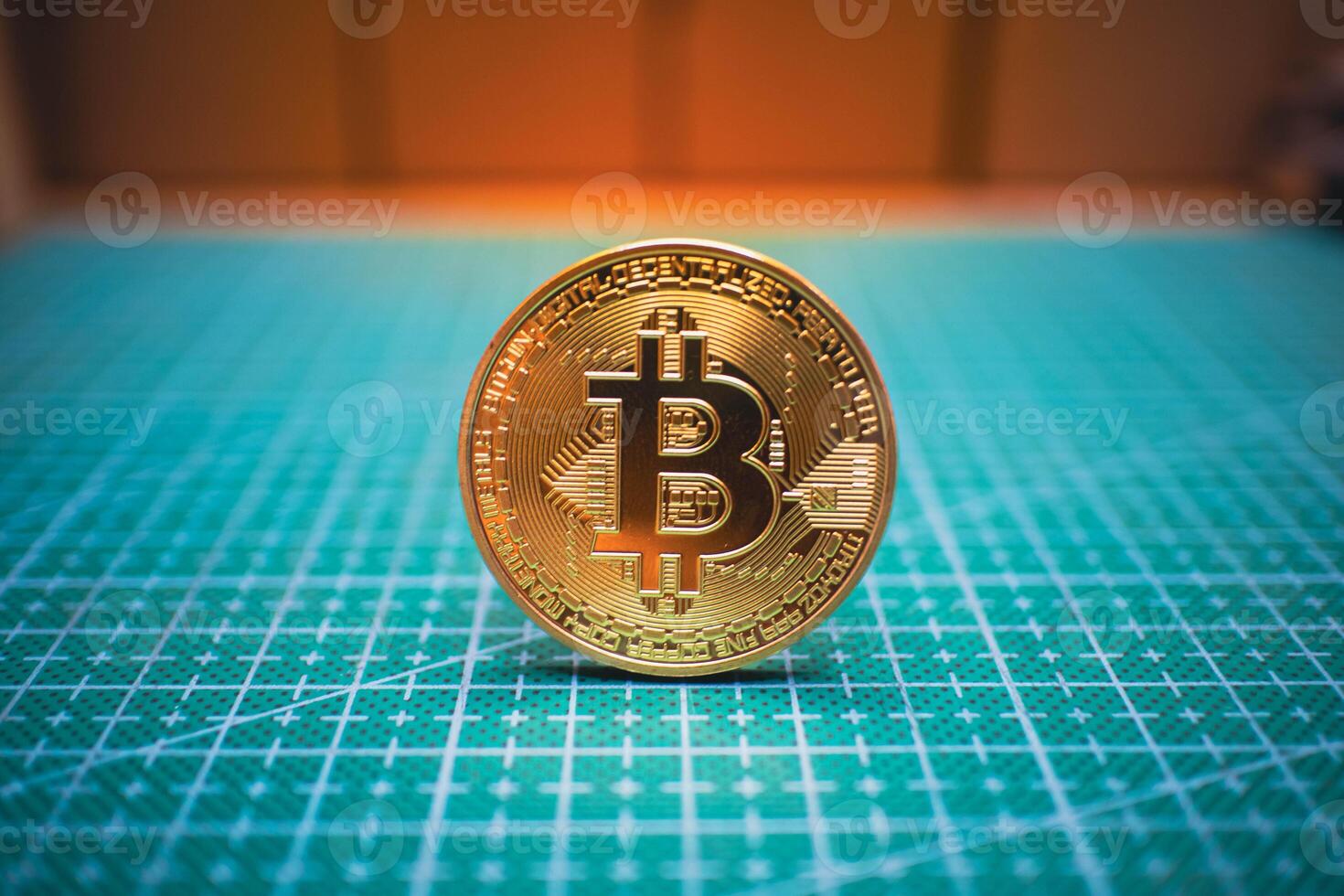 Golden Bitcoin Coin on Green Grid Background. photo